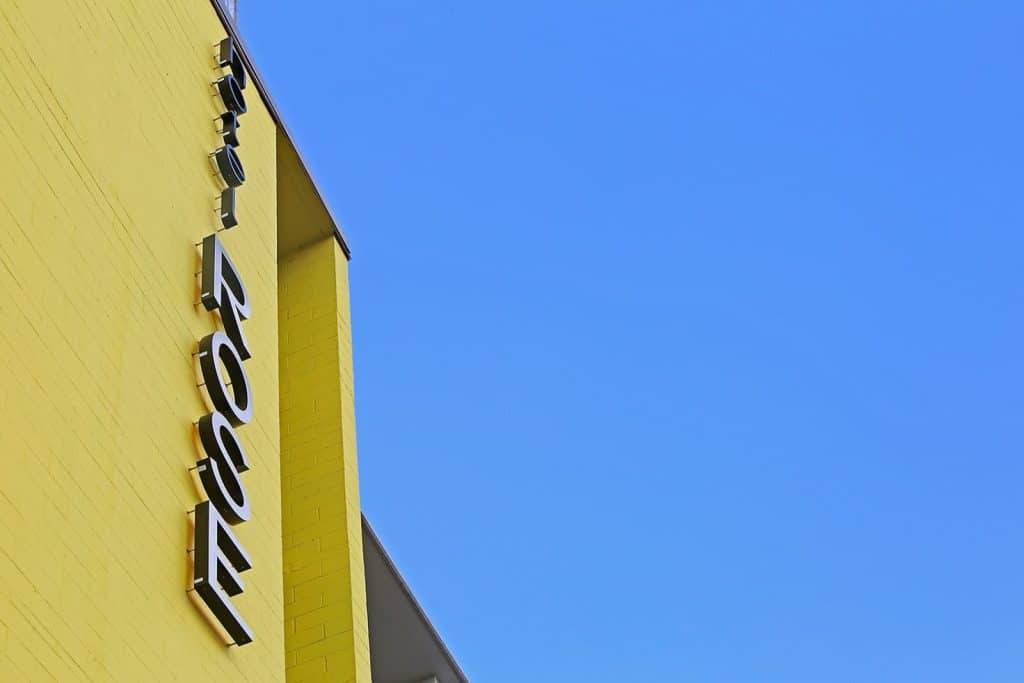 Side view of a yellow building with the word "Focus" in metallic letters against a clear blue sky.