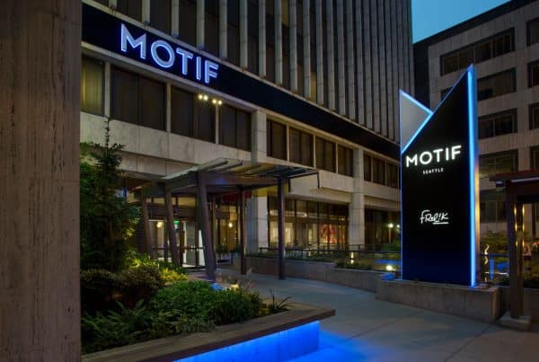 Exterior of the Motif Seattle hotel with illuminated signage and modern architectural features.