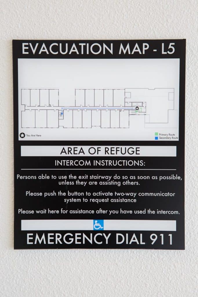 Evacuation map and instructions sign for area L5, featuring a floor plan, intercom instructions, and emergency contact information.