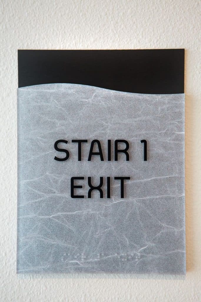 Sign on a wall reading "Stair 1 Exit.