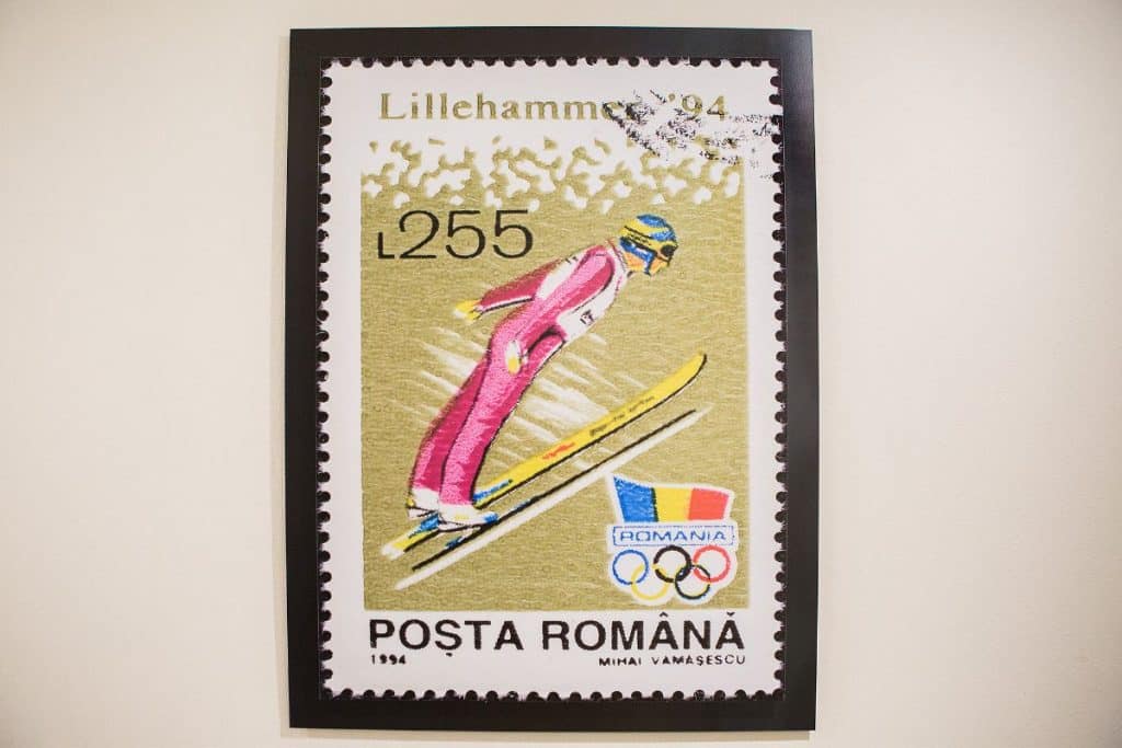 Romanian postage stamp featuring a ski jumper in a pink suit with the Lillehammer 1994 Olympics logo and "POSTA ROMÂNĂ" text.