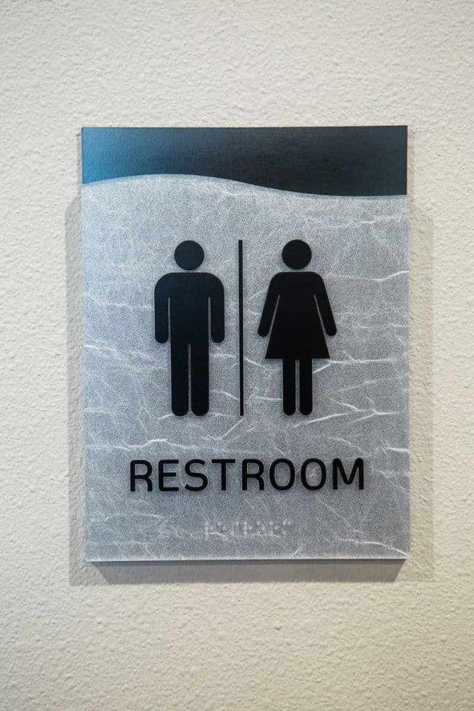 Sign with male and female symbols indicating a restroom.