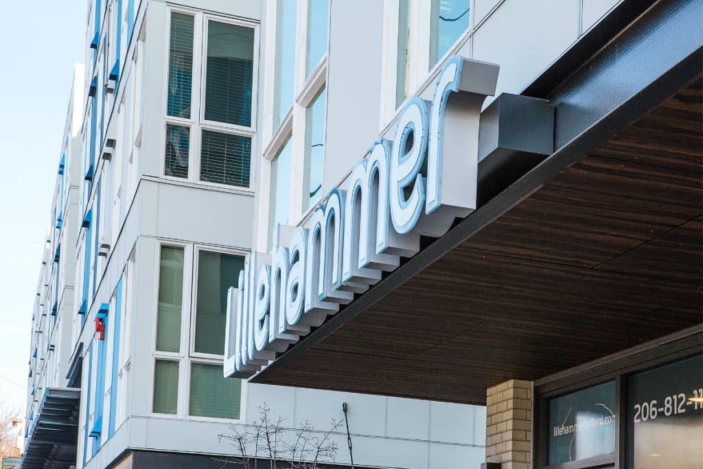 The image shows a building with a sign reading "Lillehammer" on its exterior.