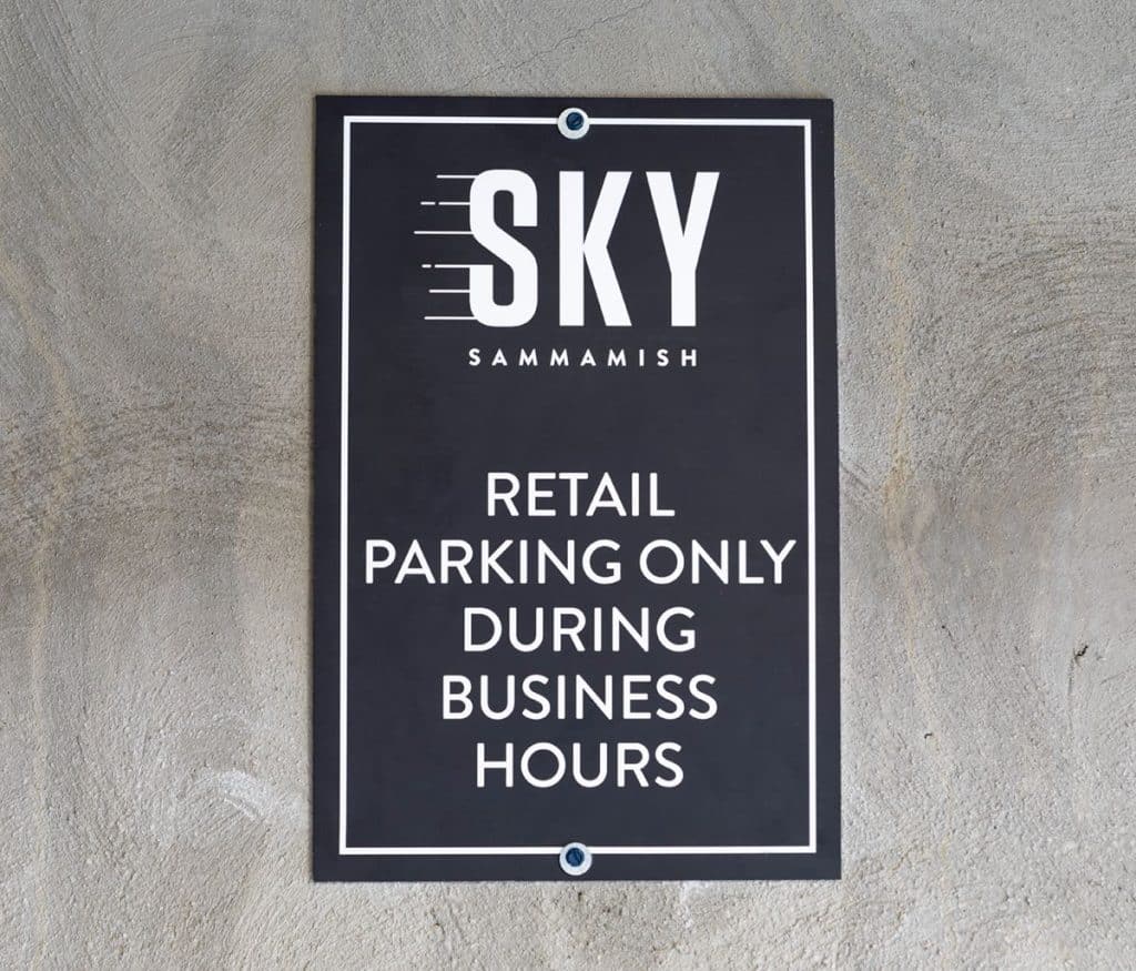 Sign on a wall reads: "Sky Sammamish, Retail Parking Only During Business Hours.