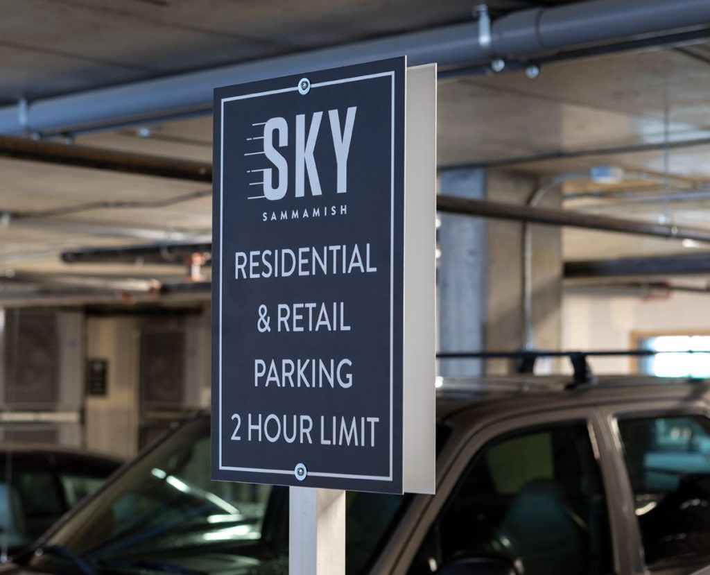 Parking sign in a garage for Sky Sammamish indicating residential and retail parking with a 2-hour limit.