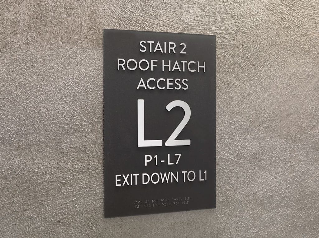 Sign on a wall: "Stair 2, Roof Hatch Access, L2, P1-L7, Exit Down to L1.