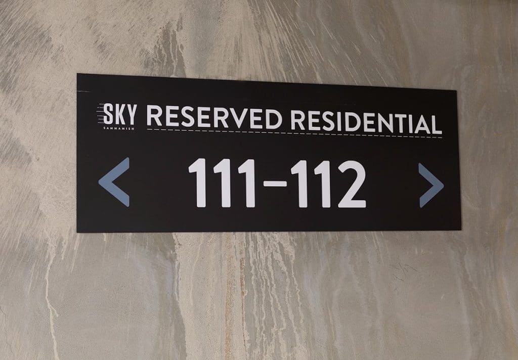 Sign reads "Sky Reserved Residential 111-112" with arrows pointing left and right.