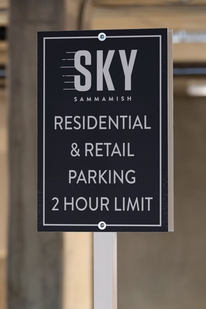 Sign reading "Sky Sammamish Residential & Retail Parking 2 Hour Limit" on a black background.