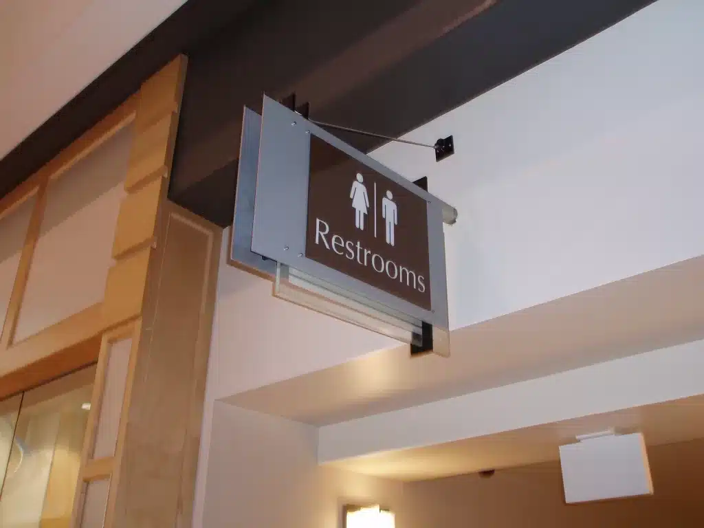 A restroom sign with male and female symbols is mounted on the wall.