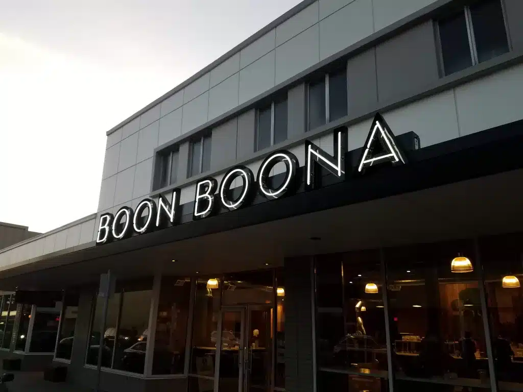 The image shows a building with a sign that reads "Boon Boona" above the entrance, featuring large, illuminated letters.