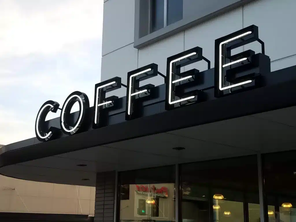 Neon sign displaying the word "COFFEE" on the exterior of a building.